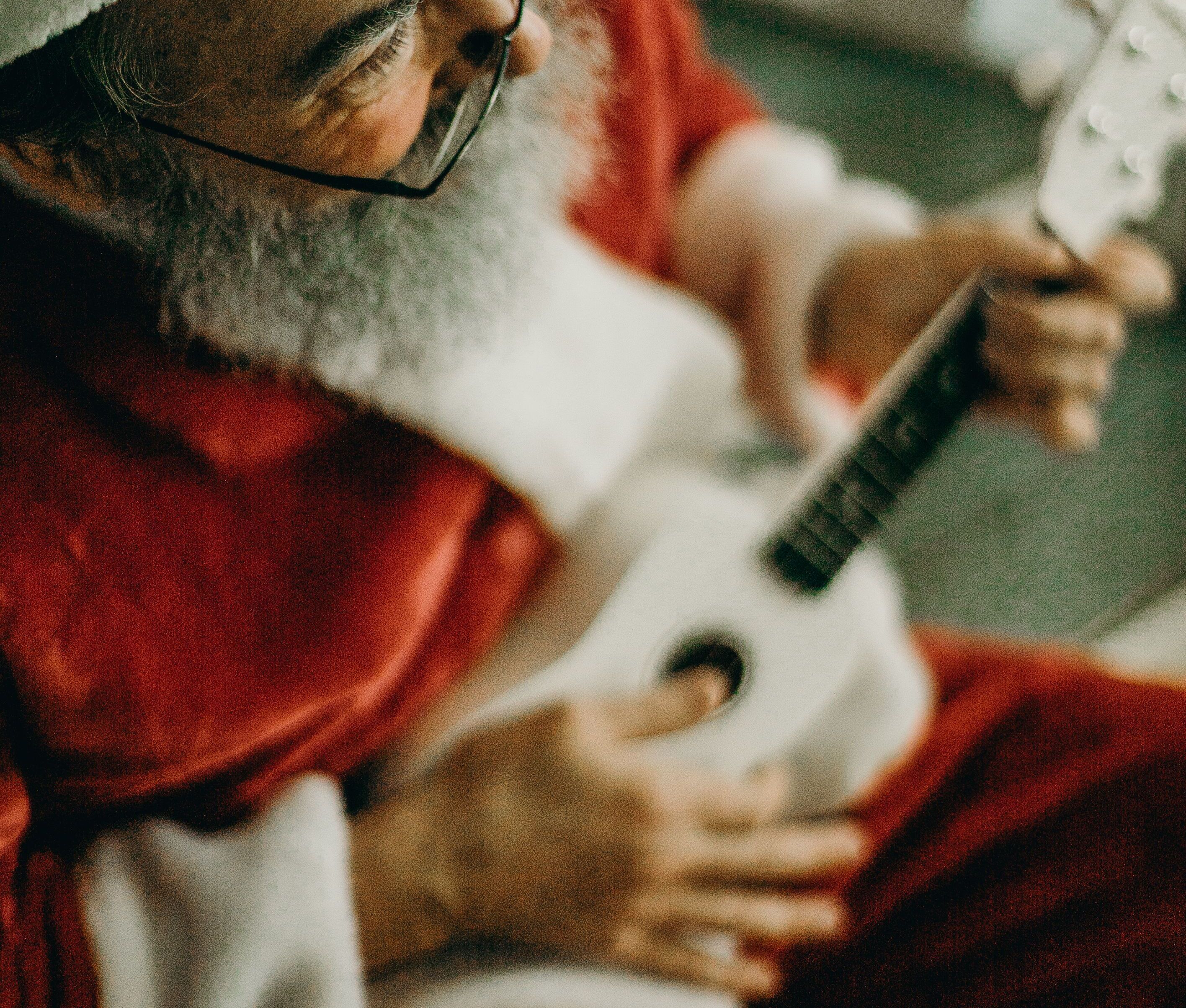 Santa creating a Christmas song to submit on PlaylistsForYou, the platform that pitches to only true Christmas playlists.